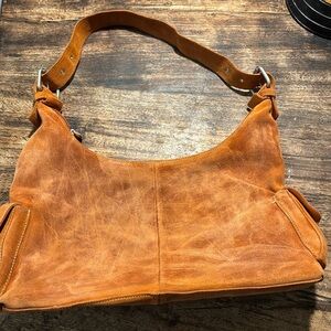 Orange suede shoulder bag with an organic rustic look